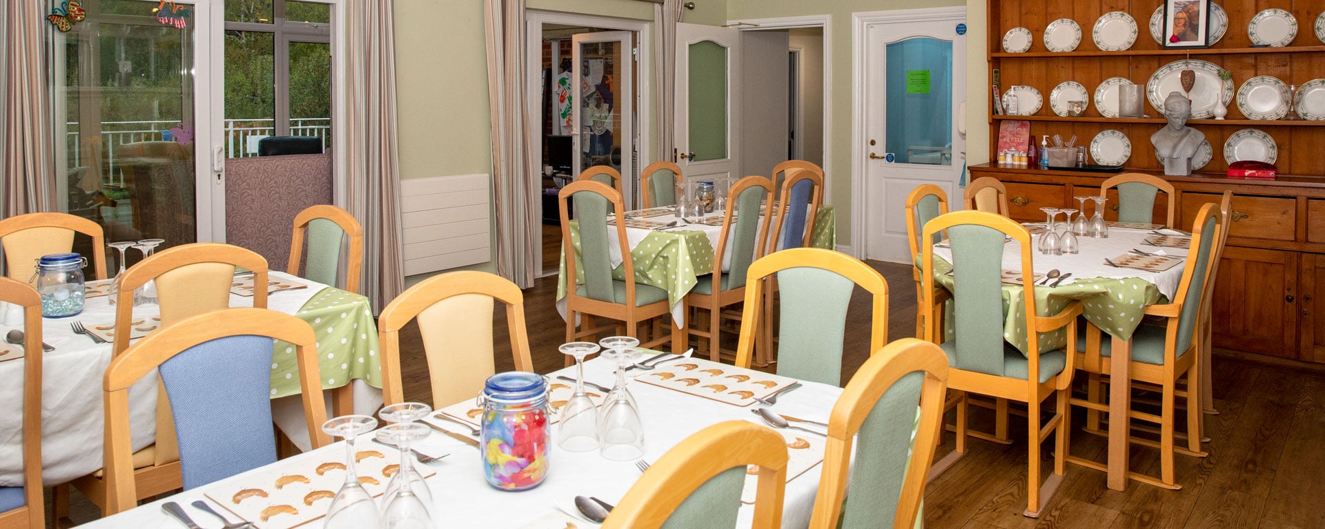 Full view of the care home's dining room ready for lunch