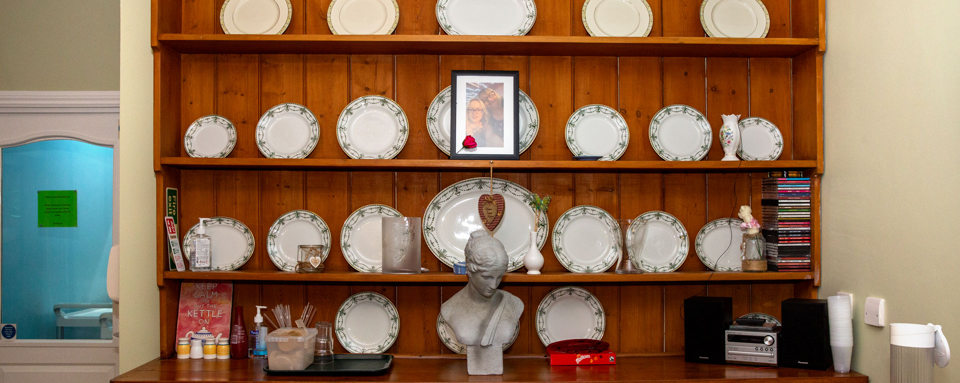 Book shelf with plates and decorations on