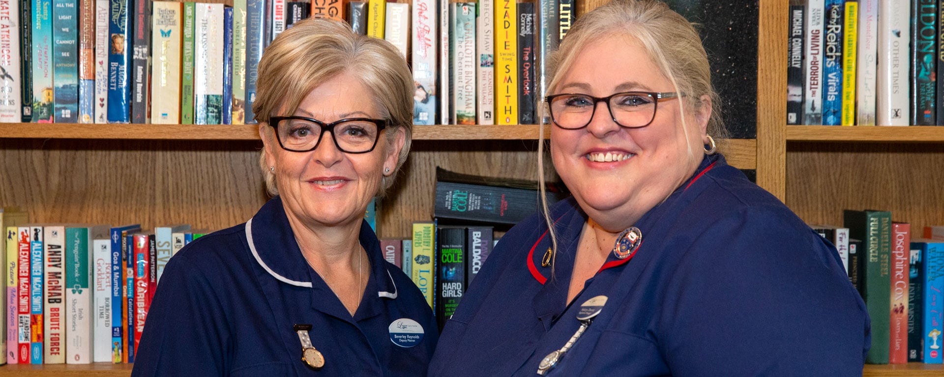 Senior nursing and management staff smiling in the library