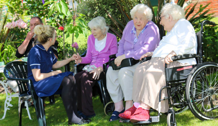 Relatives having a chat in the garden in the summer