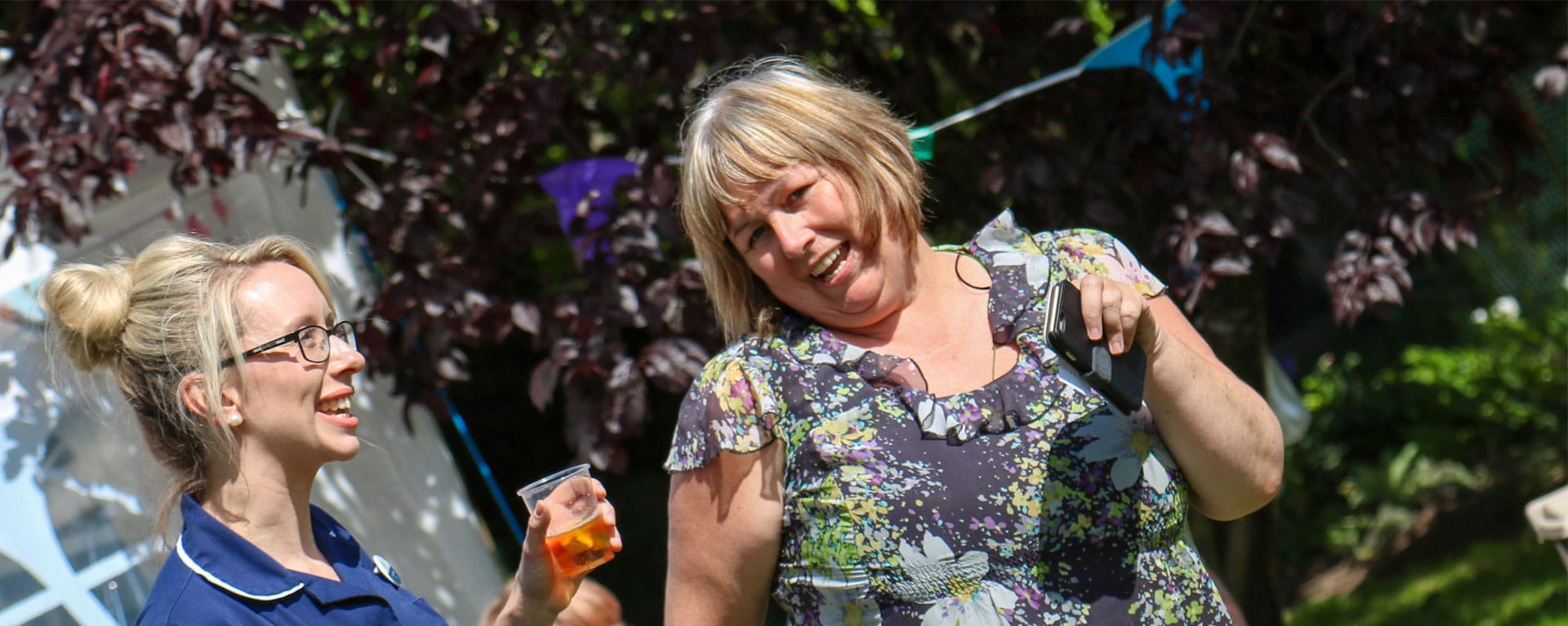 Laurel Care Home Nurse and family member in the garden