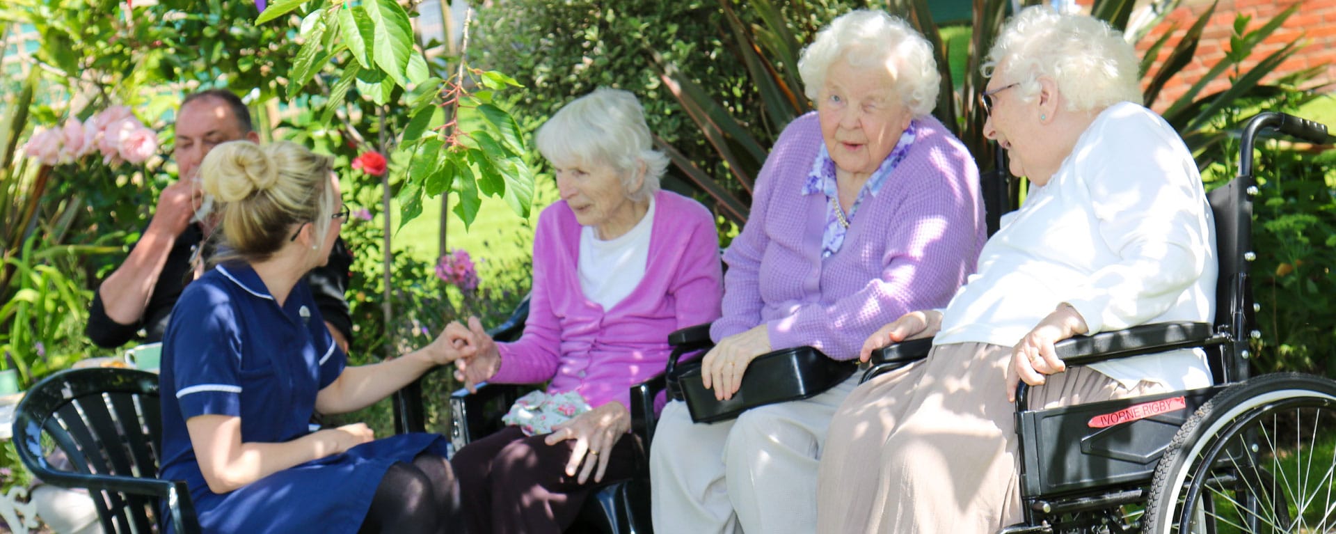 Relatives having a chat in the garden in the summer