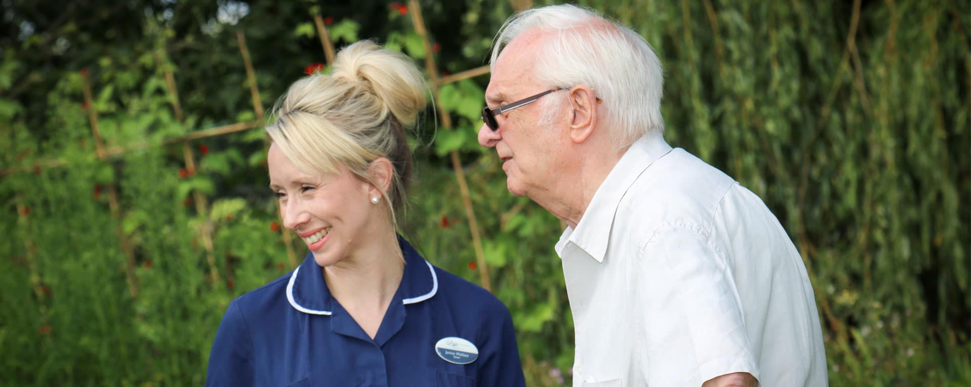 Nurse and resident having a chat in the garden