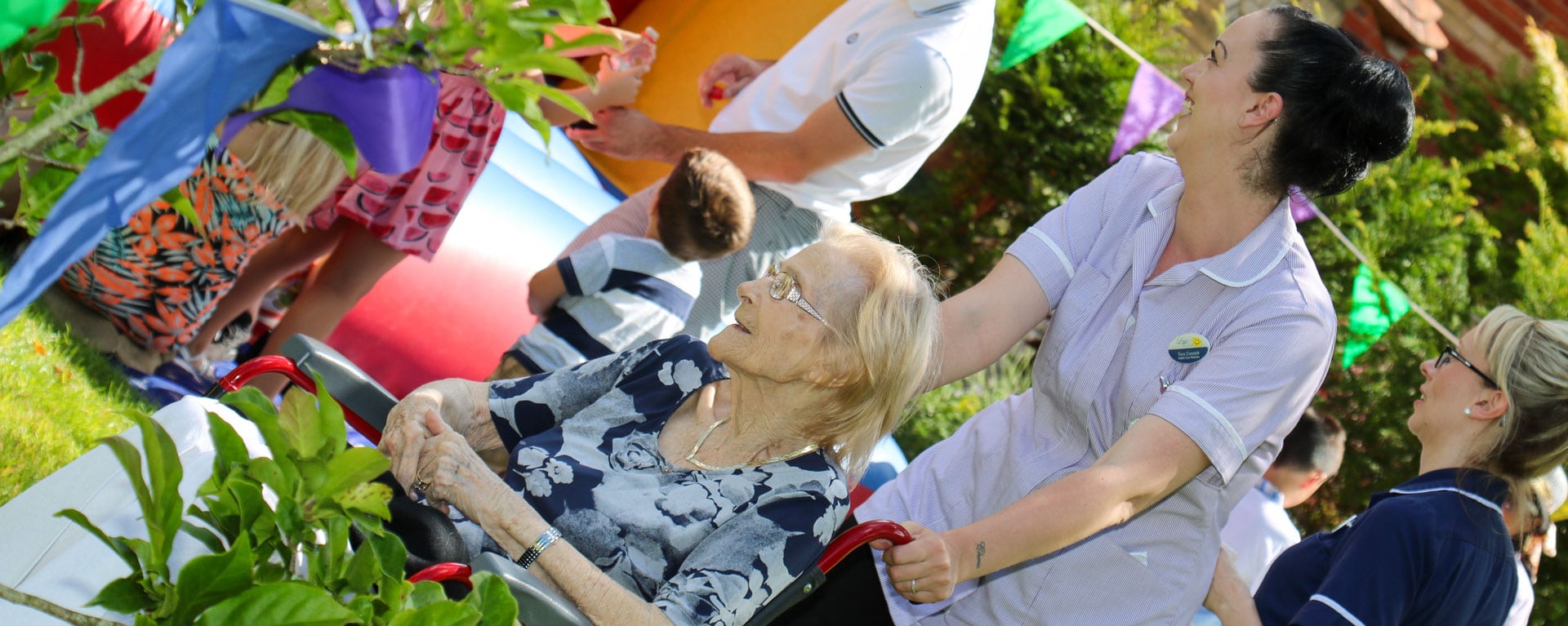 Resident being pushed through Laurel Care Homes fete laughing
