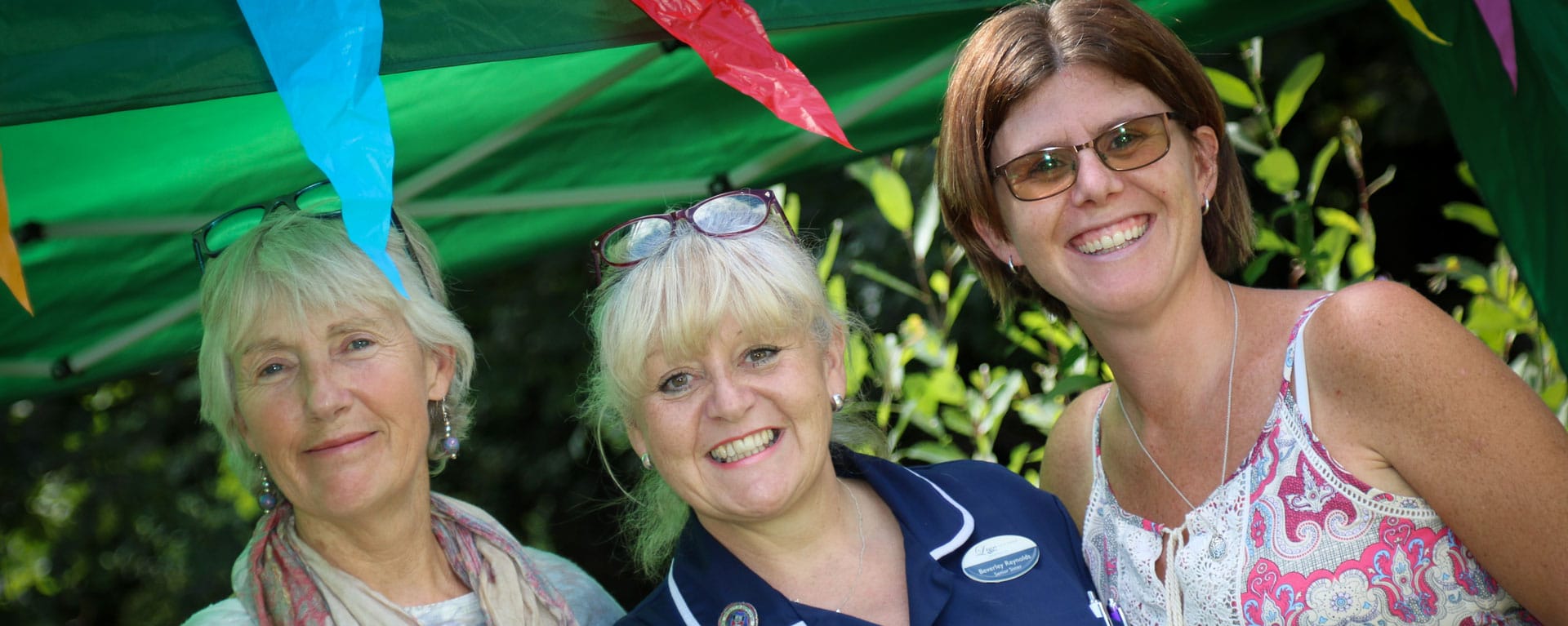 Nurse and residents family members smiling at the fete