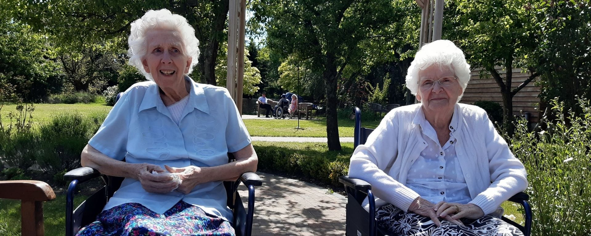 Two residents sitting in the garden