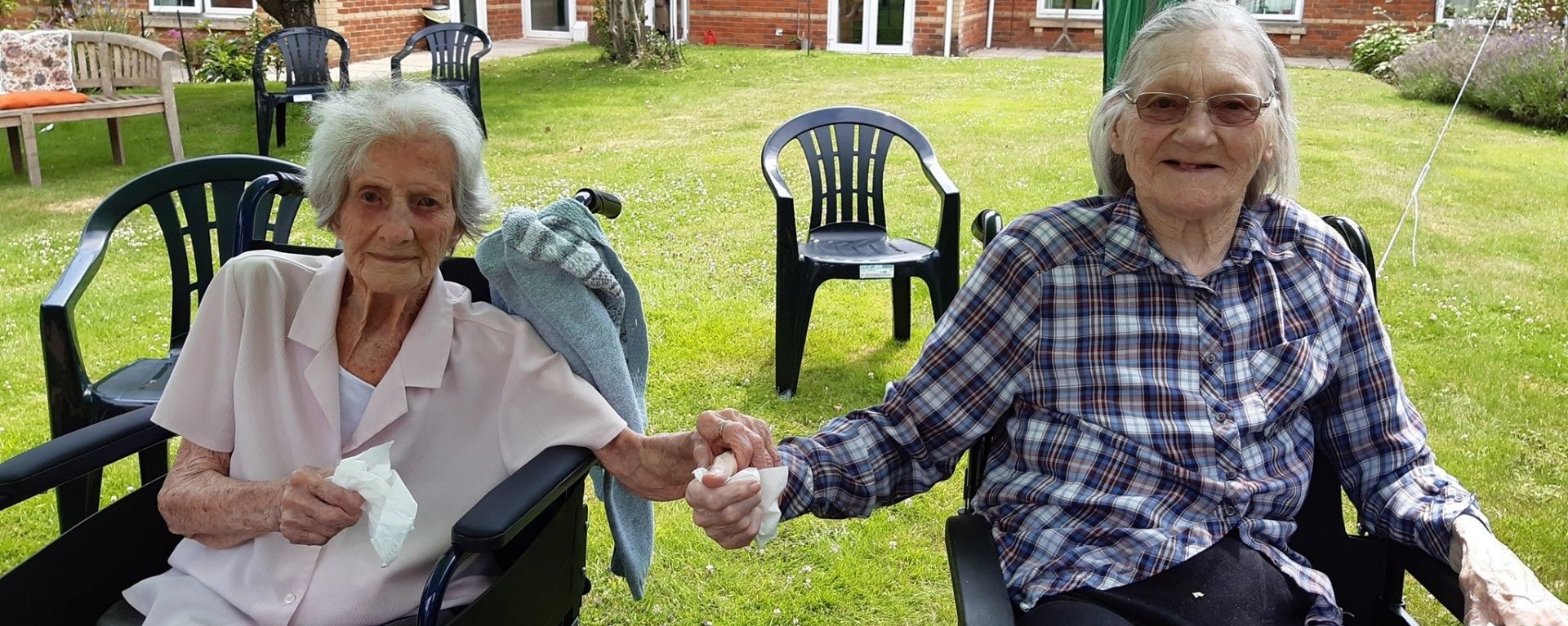 Laurel Care home residents holding hands in the garden